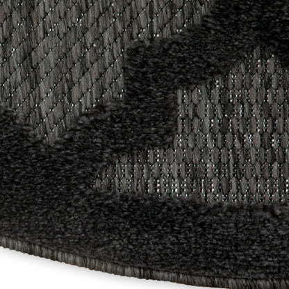 Charcoal gray woven rug with black plush border; textured loop-pile, cozy modern style.