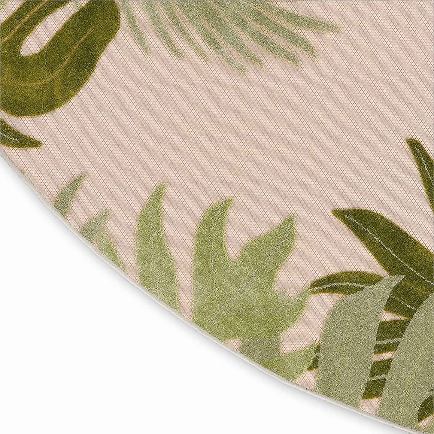 Beige round outdoor rug with green tropical leaf print and subtle woven texture, 5' round.