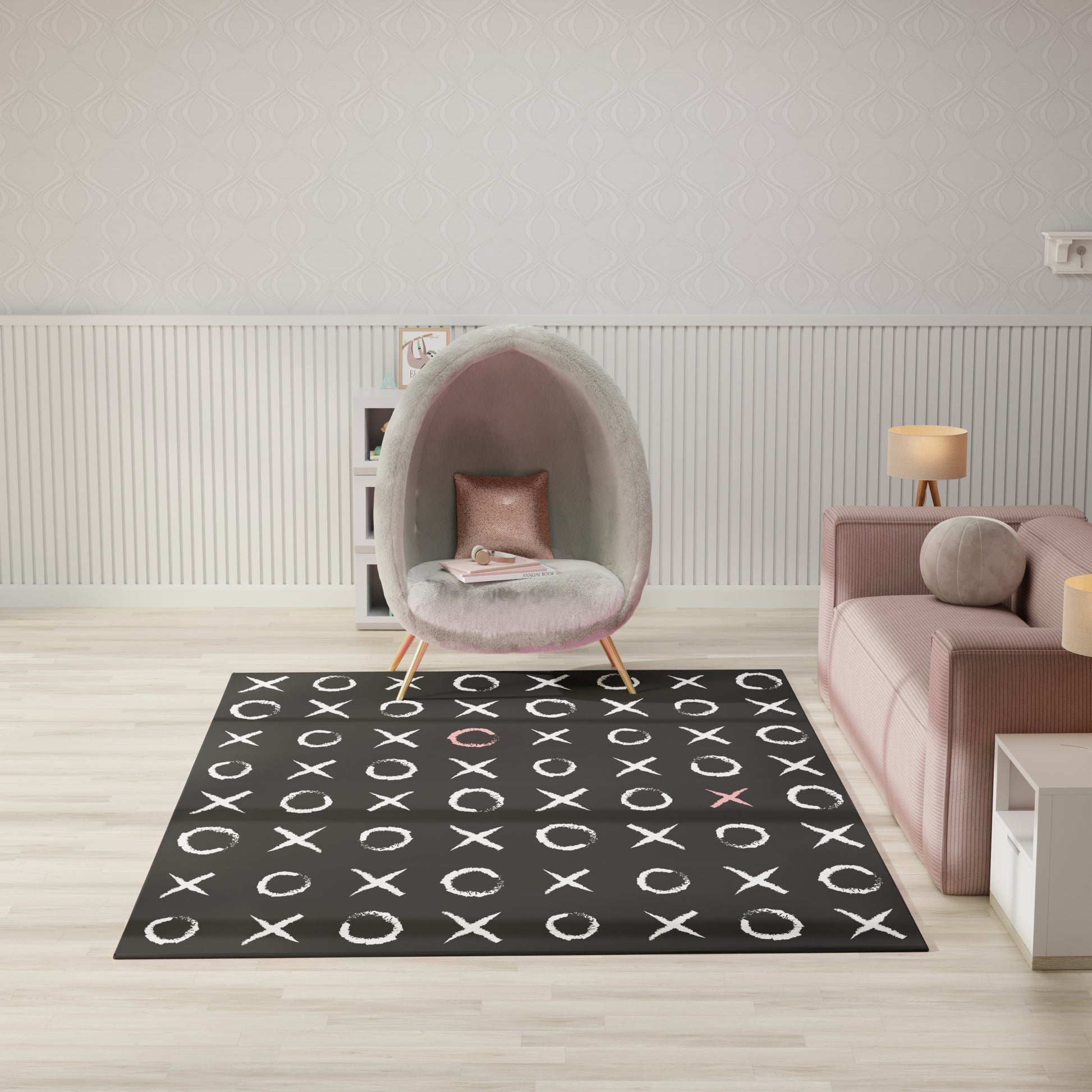 Black rug with white X and O pattern, pink accent Os, in a modern living room with a grey pod chair and pink sofa.