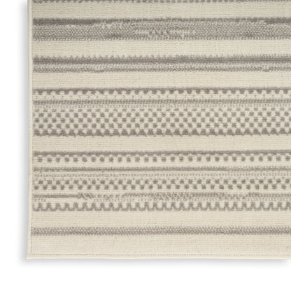 Beige and gray woven rug with multiple geometric stripe patterns and dotted bands.