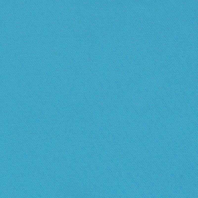 Bright blue textured fabric close-up with fine grain, solid color background.
