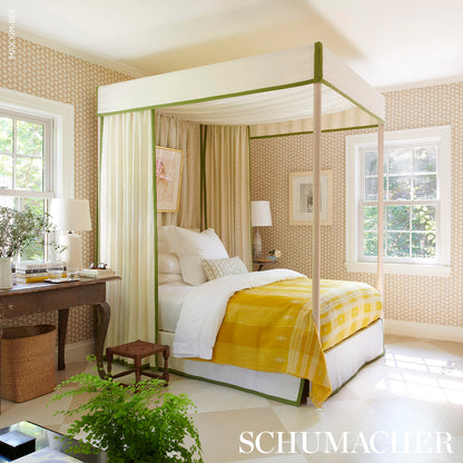 Cream four-poster bed with green trim and sheer curtains, grass-print bedding, vintage room with wallpaper and plants.