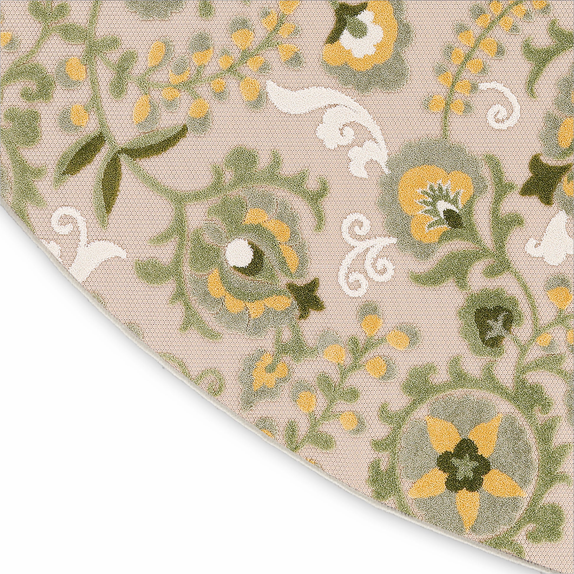 Beige floral area rug corner with green vines, yellow flowers, white scrolls; woven texture, curved edge.