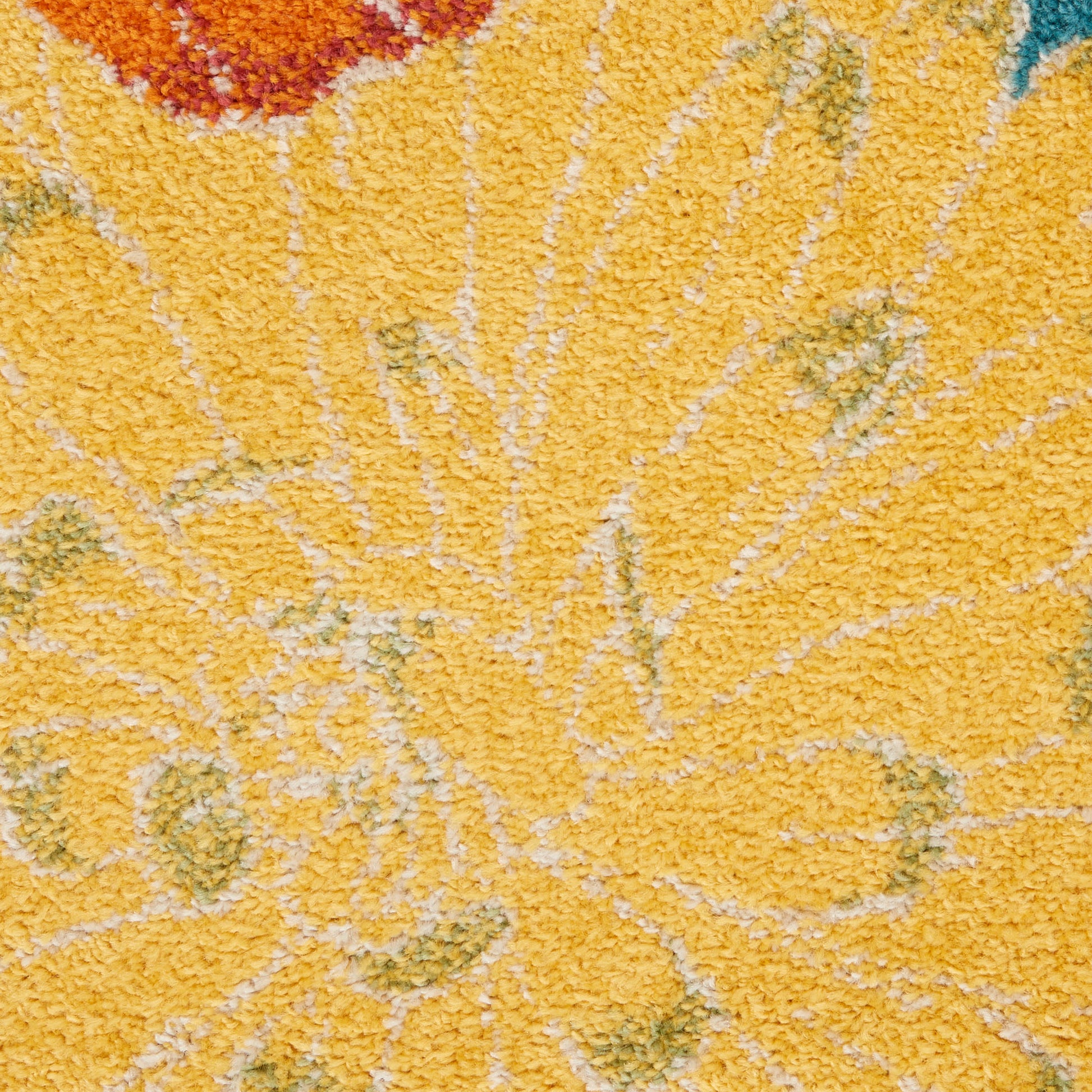 Close-up of bright yellow shag rug with abstract floral pattern in orange, green & teal.