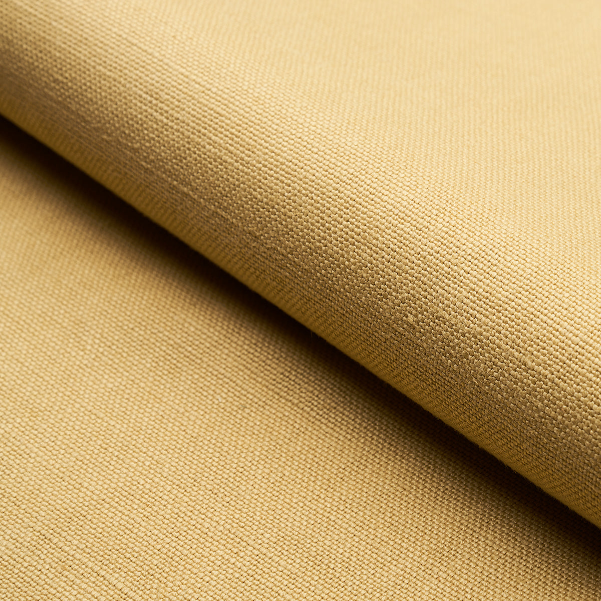 Beige woven fabric roll with visible texture and folded edge; neutral upholstery or garment textile.