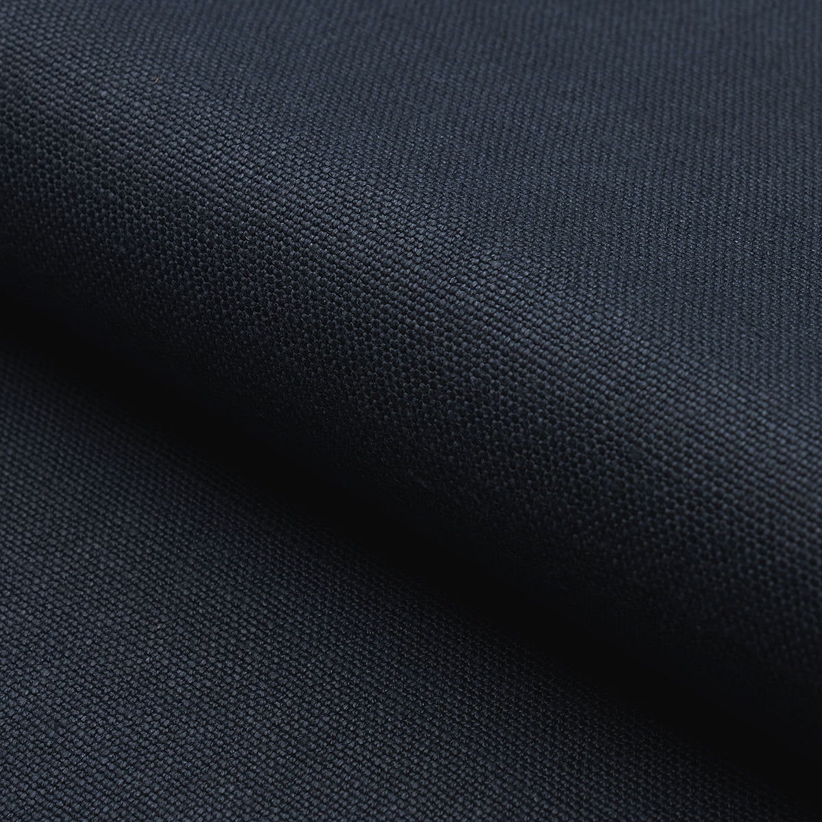 Close-up of deep navy woven fabric with a tight textured weave, suitable for apparel, bags or upholstery.