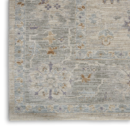 Rectangular distressed gray-blue rug with faded beige and rust floral motifs and a framed border for living rooms.