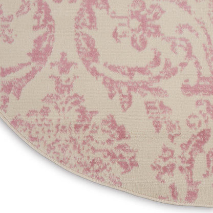 Round rug in cream with pink damask pattern; soft, textured fabric for elegant living spaces.