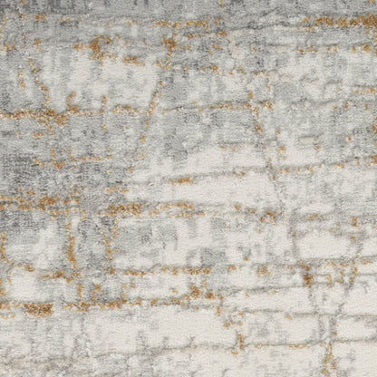 Rectangular abstract rug in light gray and ivory with subtle gold accents; modern woven texture.