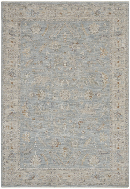 Powder-blue distressed vintage-style oriental rug with ivory-beige border and faded floral motifs.