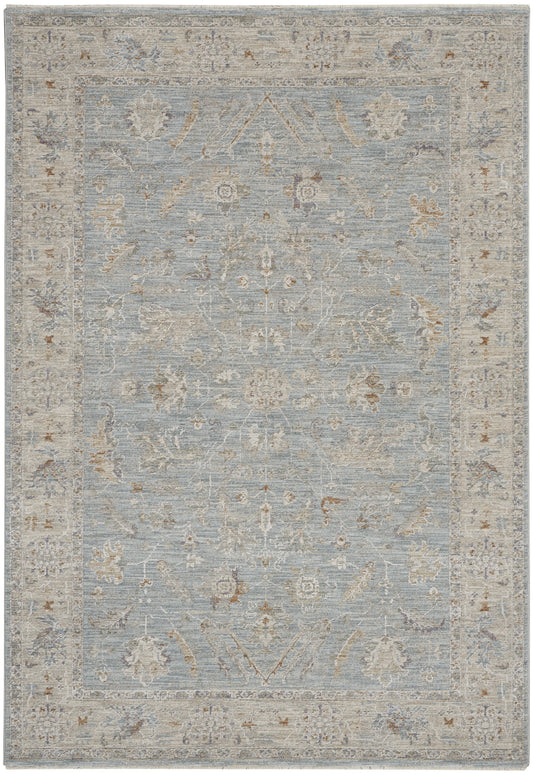 Powder-blue distressed vintage-style oriental rug with ivory-beige border and faded floral motifs.
