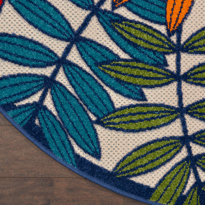 Teal leaf-patterned rug on dark wood floor; white/beige background with blue-green leaves.
