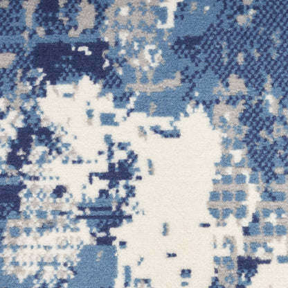 Blue and white pixelated camouflage-style fabric pattern with varying navy to light blues, ideal for apparel or upholstery