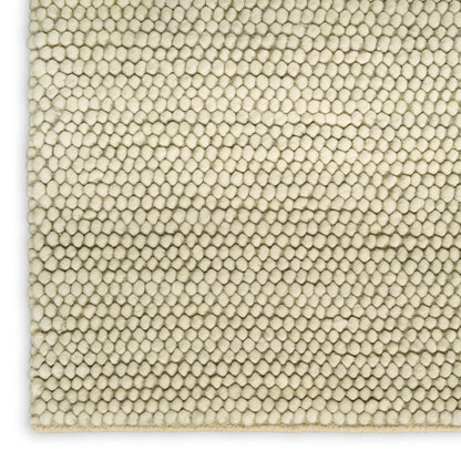 Cream boucle rug close-up with tiny pebble-like loops; soft textured woven carpet for floor use.