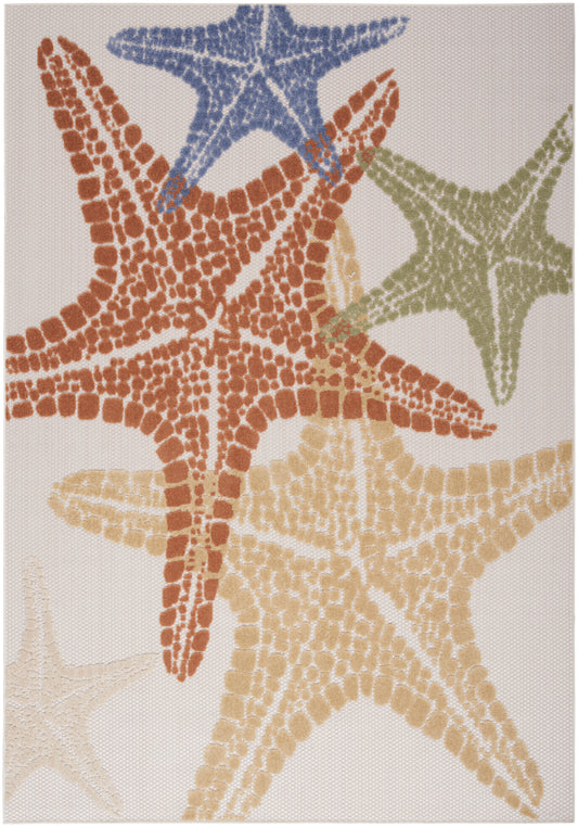 Outdoor coastal rug featuring overlapping starfish in blue, rust, olive and beige on pale background.