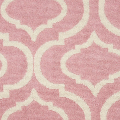 Dusty pink rug featuring a cream and white Moroccan trellis quatrefoil pattern.