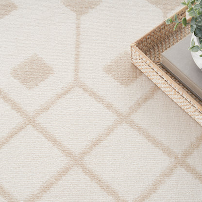 Light beige diamond-pattern rug with a woven basket, books and greenery in the top-right corner.
