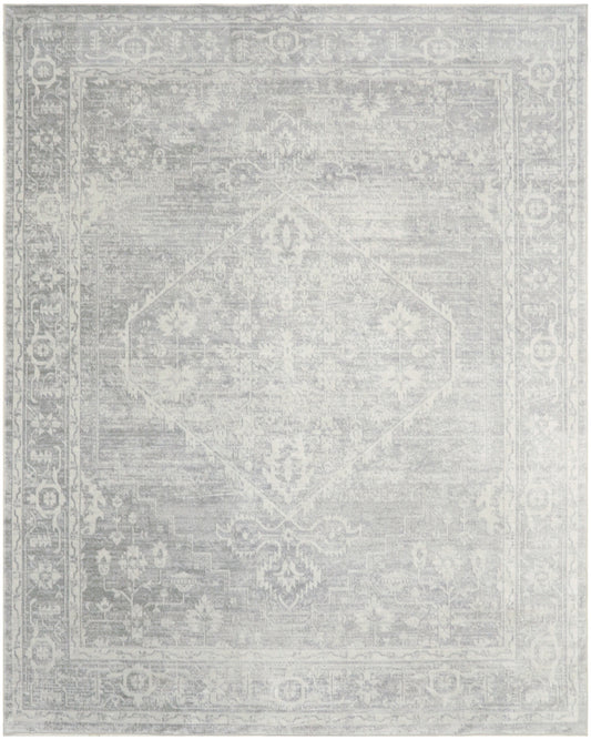 Light gray distressed Persian-style area rug with ivory border and subtle central medallion