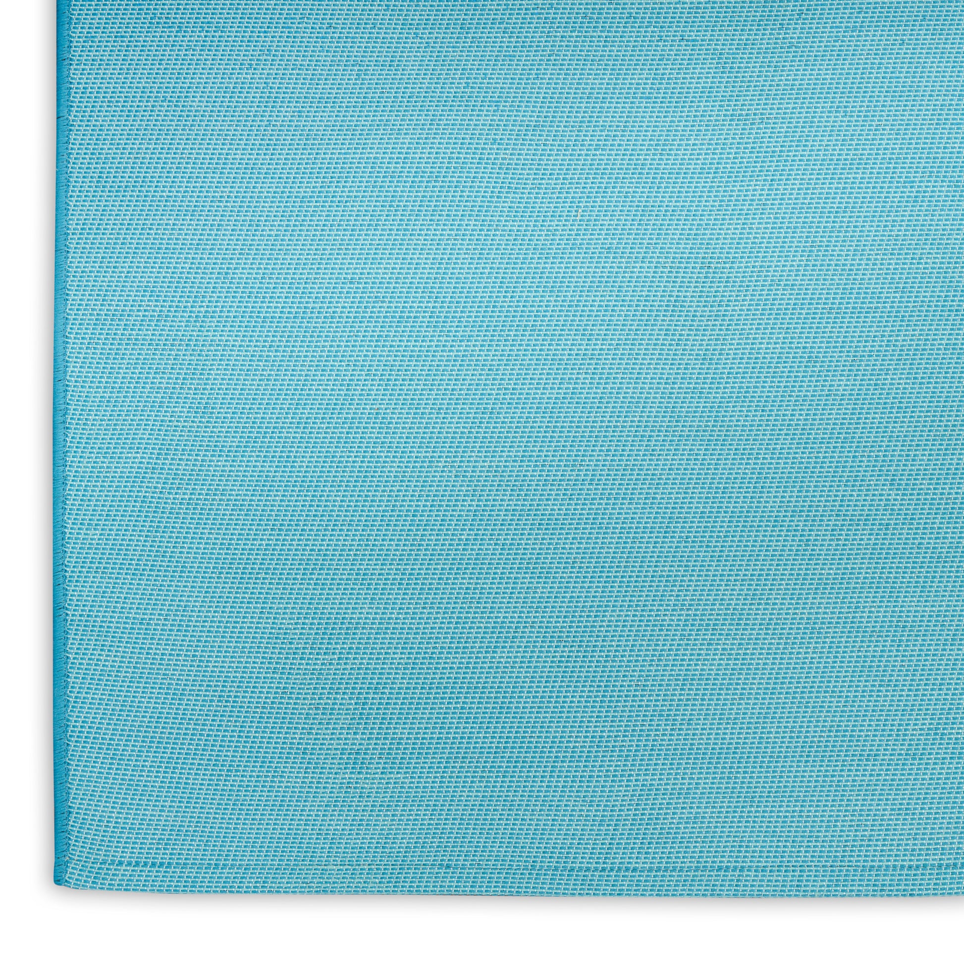 Aqua blue textured rug with a visible left edge seam and corner detail