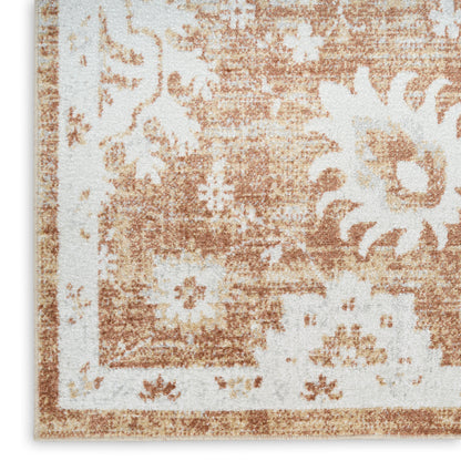 Rectangular distressed floral rug in peach and ivory with a decorative border and large flower motifs.