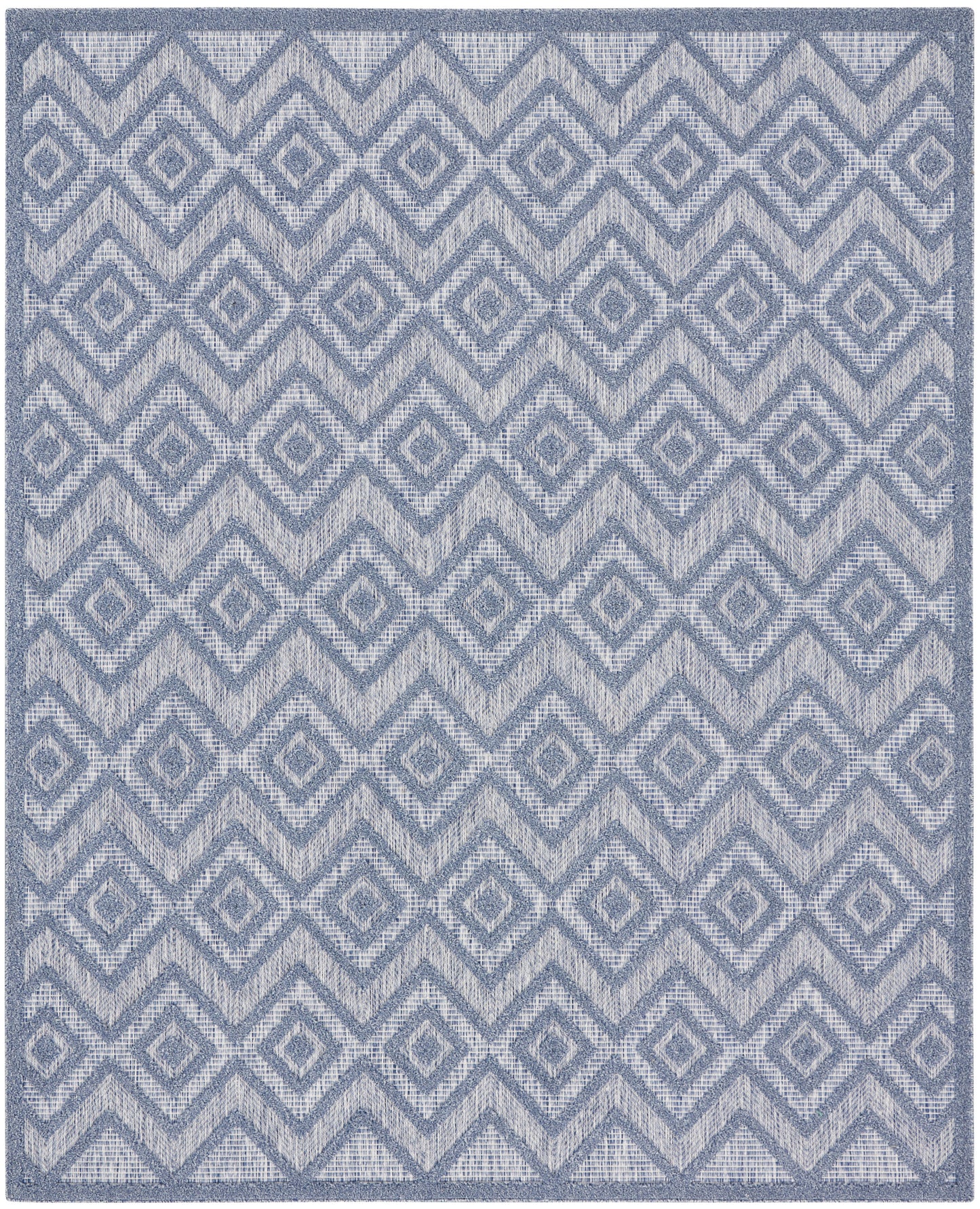 Blue-gray geometric rug with a repeating diamond/chevron pattern and textured weave.