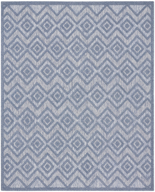 Blue-gray geometric rug with a repeating diamond/chevron pattern and textured weave.