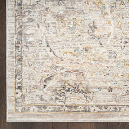 Beige distressed oriental rug with faded floral medallion, ornate border, blue and gold accents on a wood floor.