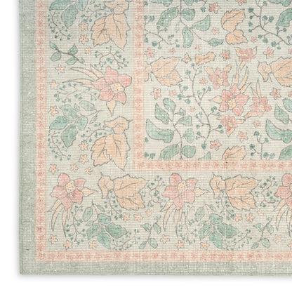 Pastel floral runner rug corner with mint, peach & pink blossoms, woven texture & decorative border.