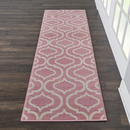 Pink runner rug with cream trellis pattern on dark wood floor; soft, decorative hallway accent.