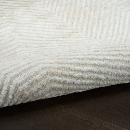 White plush rug with thick ribbed pile on dark wood floor.