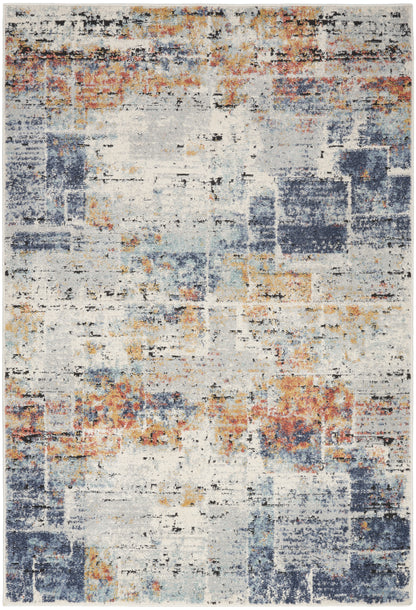 Rectangular 5' x 7' abstract distressed area rug with ivory base and blue, navy, orange, and mustard blotches.