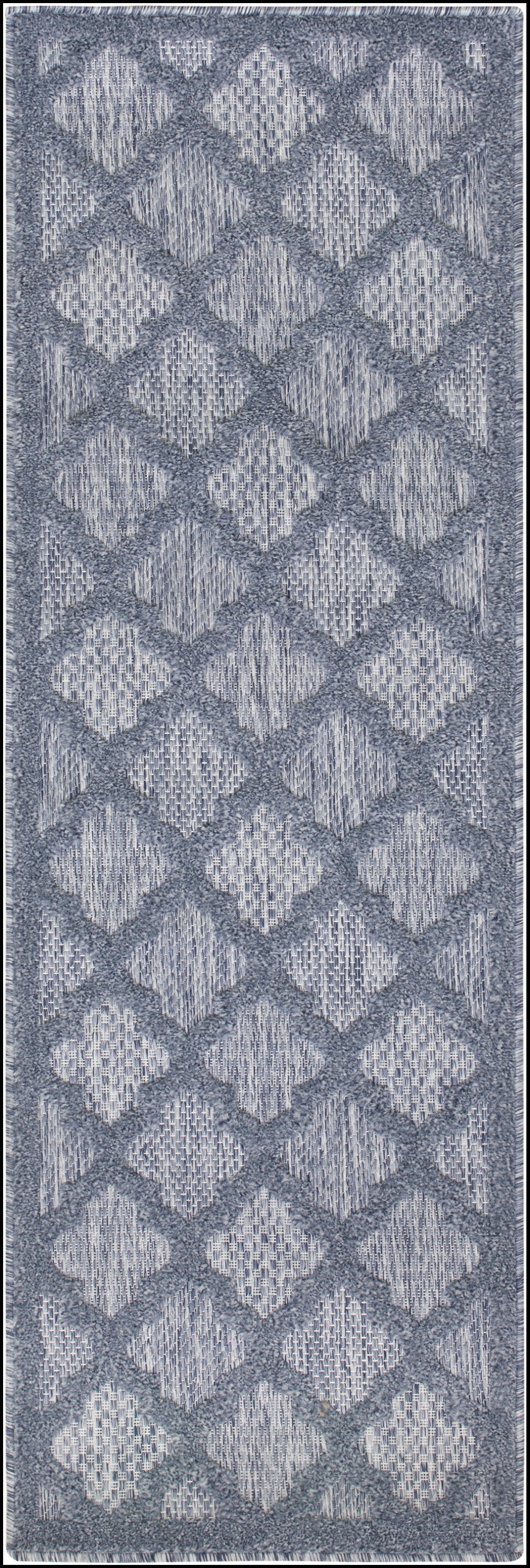 Blue-gray diamond lattice area rug with plush pile and fringed edges.