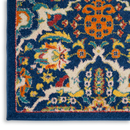 Bohemian-style rug corner with blue field, floral motifs, orange medallion, teal and yellow accents, dark blue border.
