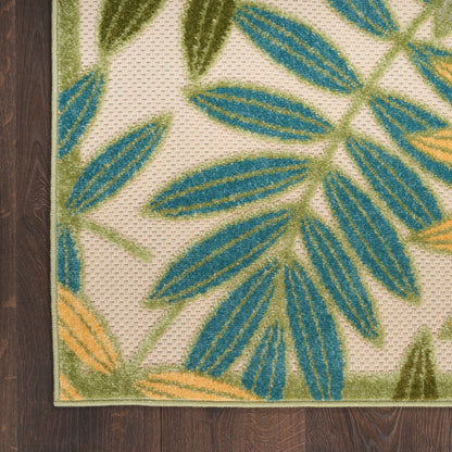 Beige woven outdoor area rug with teal blue and olive green leaf pattern, orange accents and a green border.