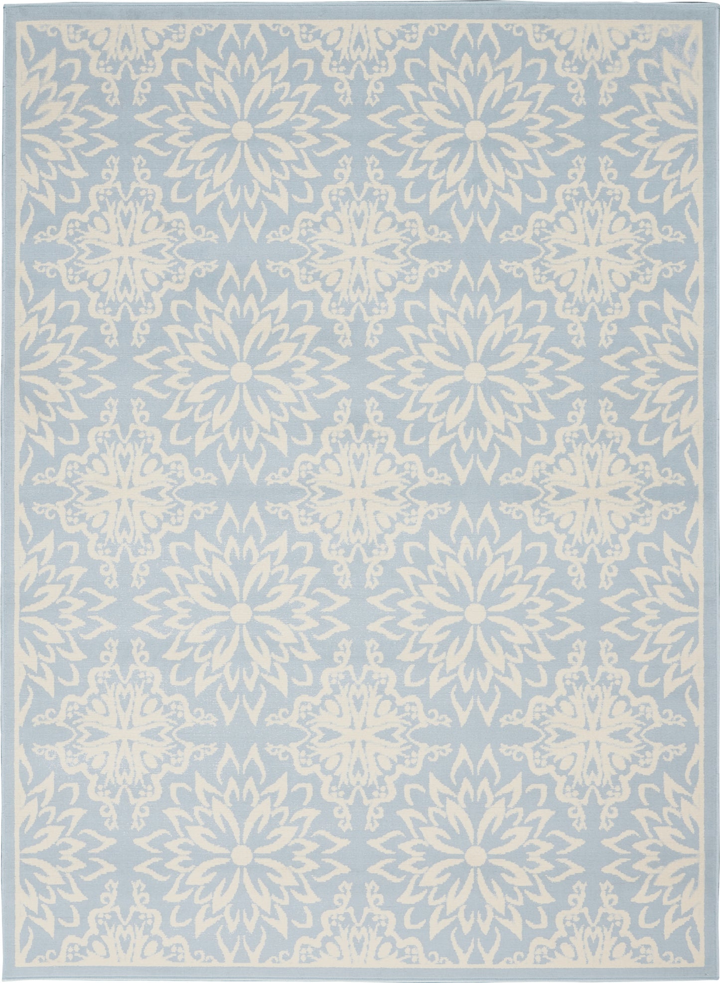 Light blue area rug with white ornate mandala-like floral medallions in a repeating pattern and a pale border.