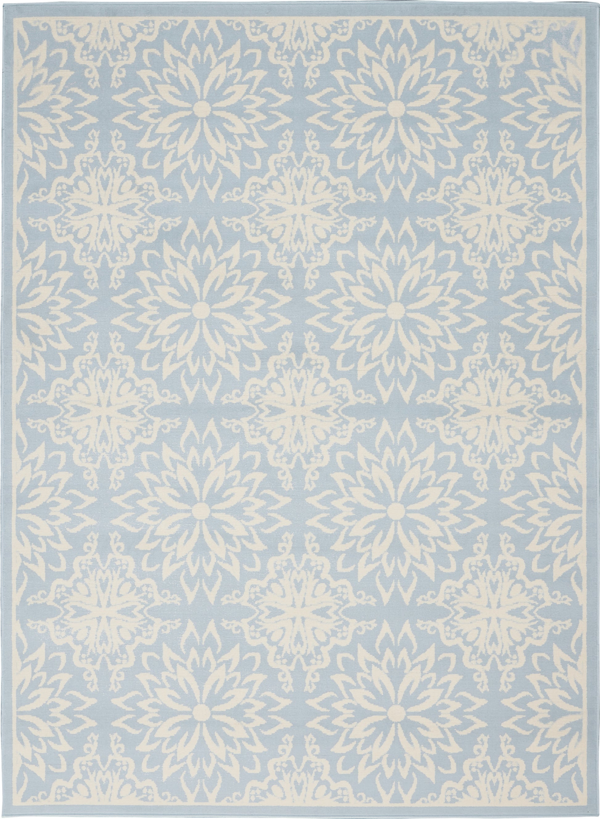 Light blue area rug with white ornate mandala-like floral medallions in a repeating pattern and a pale border.