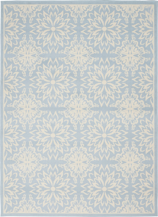 Light blue area rug with white ornate mandala-like floral medallions in a repeating pattern and a pale border.