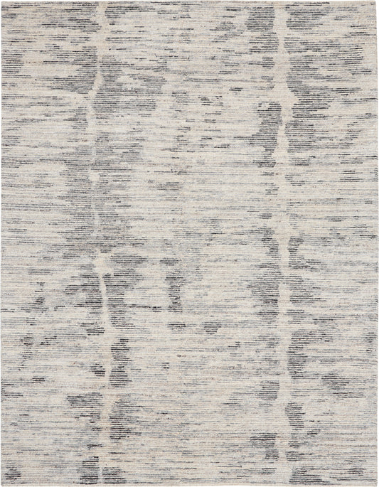 Rectangular area rug in cream with cool gray abstract linear pattern and textured weave.