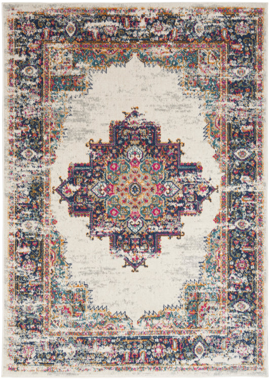 Distressed Persian-inspired rug with cream field, central medallion, and multicolor border in navy, teal, pink, and gold.