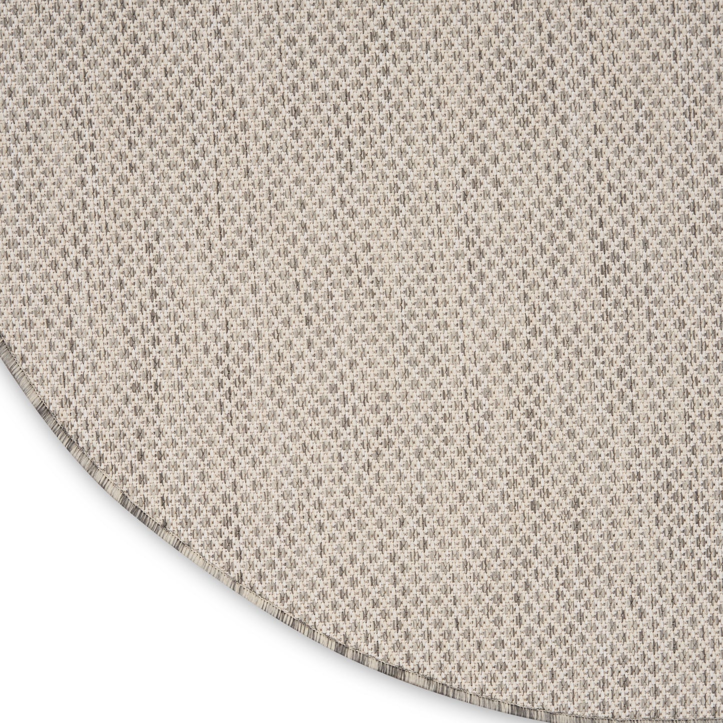 Beige round woven placemat with subtle diamond texture; natural linen look, ideal for dining tables.