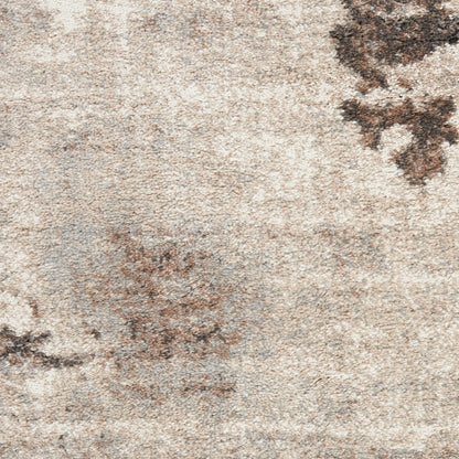 Beige distressed area rug with subtle brown floral motifs and soft, textured surface.