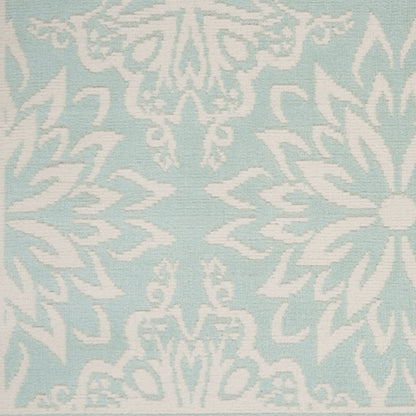 Light aqua rug with a white damask floral pattern; woven textile texture; 5' x 7'.