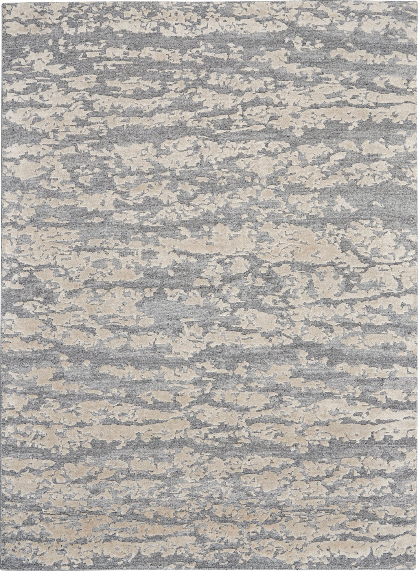 Rectangular gray-blue rug with cream cloudlike abstract pattern; soft woven texture, modern coastal style.