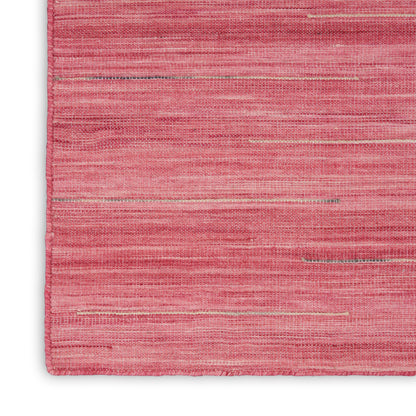 Pink woven rug with subtle horizontal stripes and soft gradient tones; flat-weave textile for modern living room decor.
