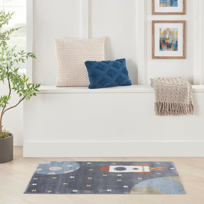 Cozy seating nook with beige knit pillow, blue diamond-pattern pillow, fringed throw, plant, abstract art, and space rug.