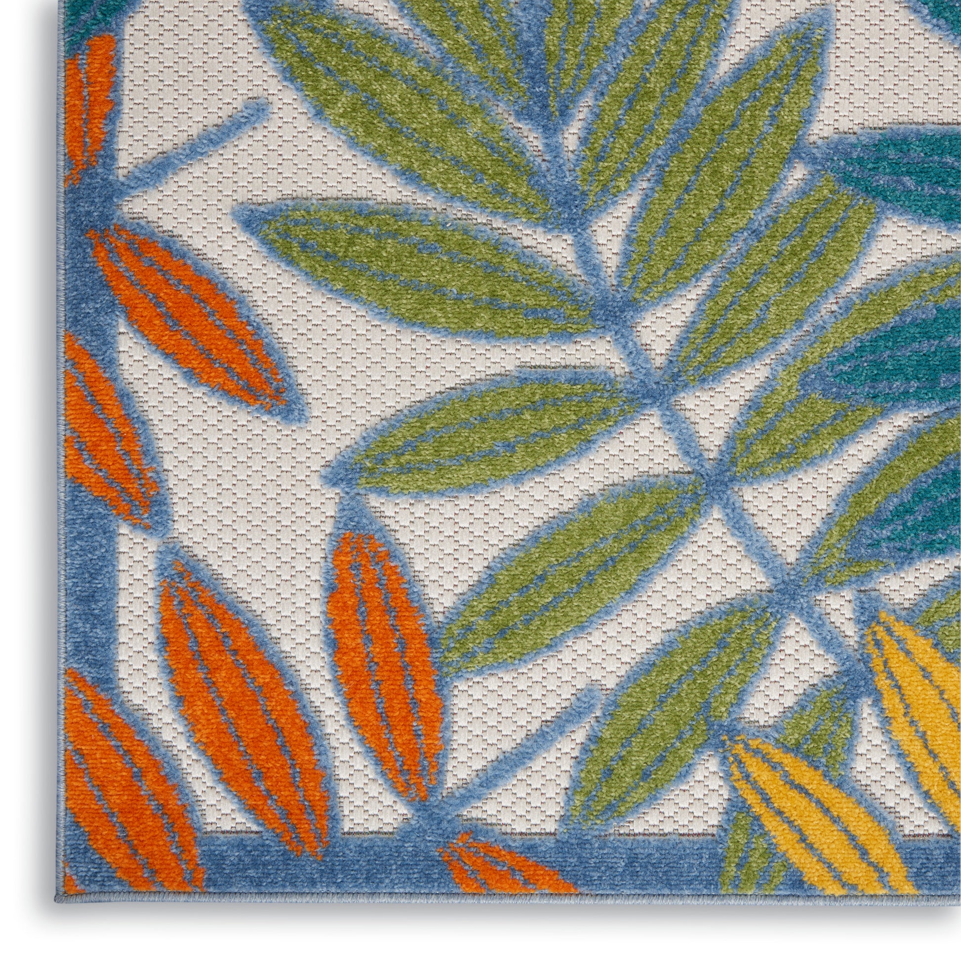 Close-up of a textile with embroidered leaf pattern in blue, green, orange on white background with blue border.