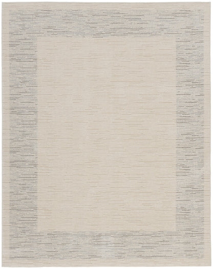 Rectangular flat-weave rug with warm beige center and textured gray border; modern neutral decor.