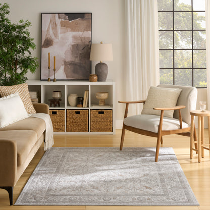 Cozy modern living room with beige sofa, wooden armchair, white cubby shelf, wicker baskets, abstract art, plant, and gray rug.