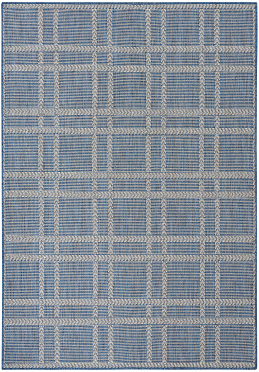 Blue woven rug with cream braided grid pattern forming rectangular blocks; modern geometric style, indoor use.