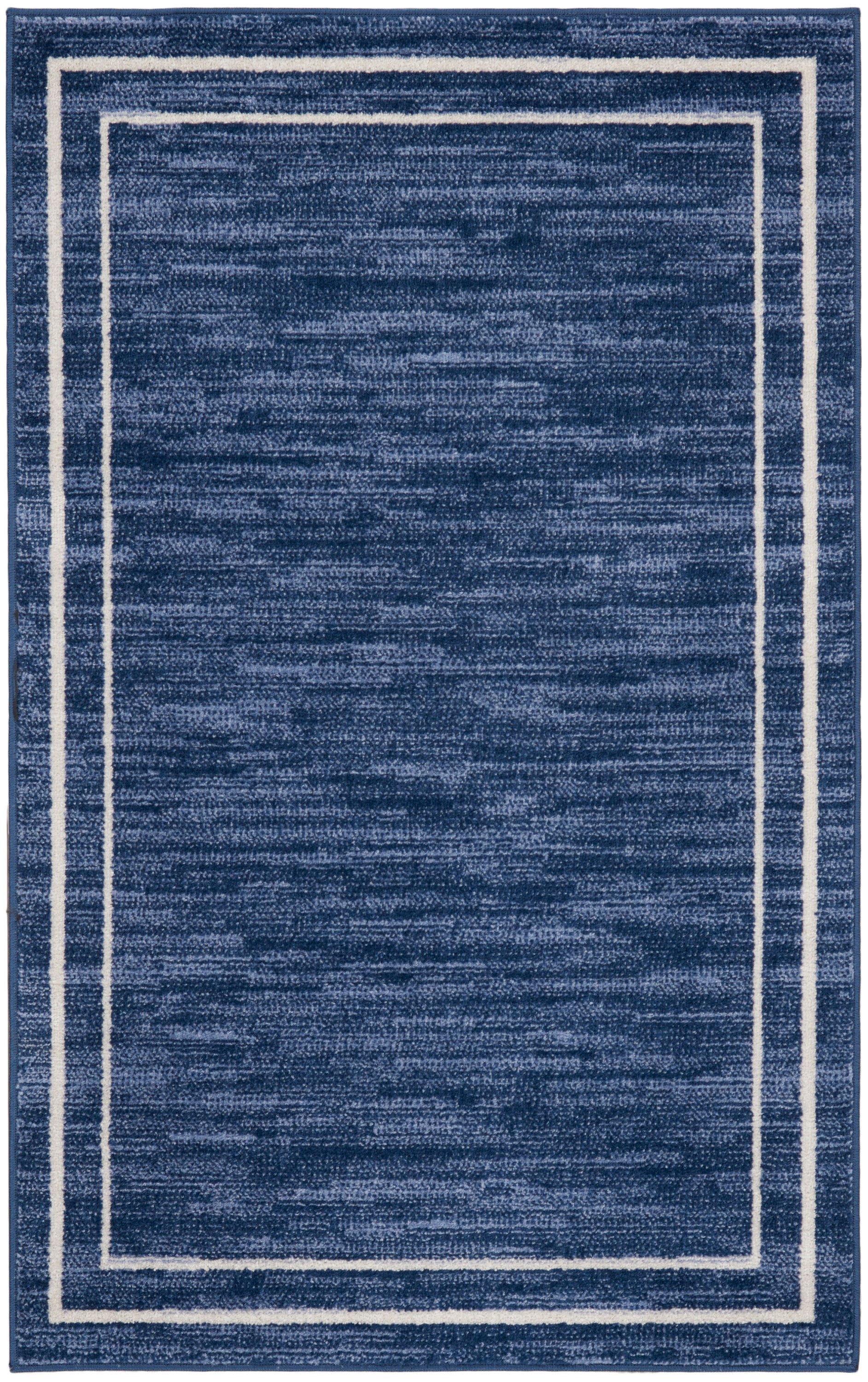 Navy blue rectangular rug with a white double-border frame near the edges; plush textured surface, modern minimalist style.